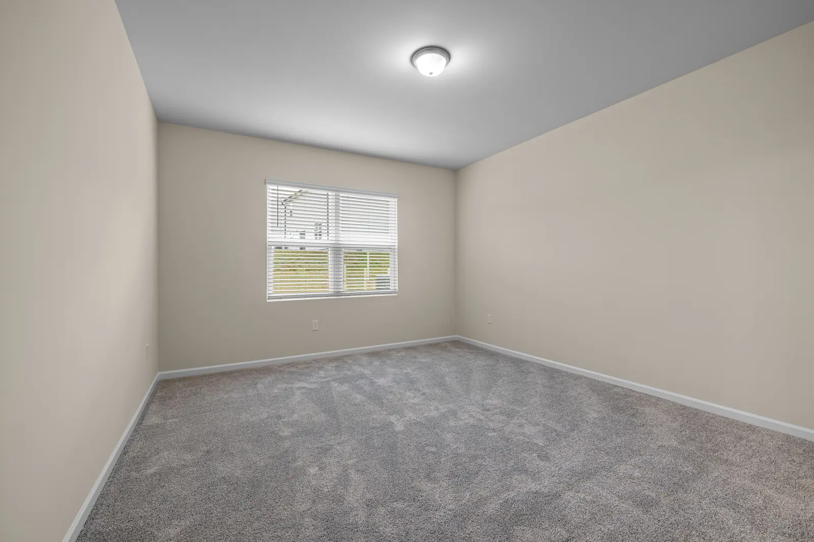 Empty rental room with fresh grey carpet, the standard an end of lease carpet clean in Ballarat has to meet